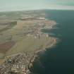 General oblique aerial view looking along the southern coastline of Fife across the villages, taken from the SW.