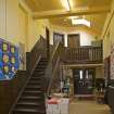 Interior. Ground floor.Original school hall. Stair to 1st level.