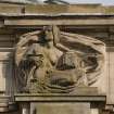 Detail of carved figure, representing 'Municipal Beneficence', on S side of W entrance