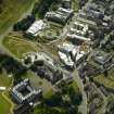 Oblique aerial view centred on the Scottish Parliament with the exhibition centre and palace adjacent, taken from the NE.