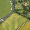 Oblique aerial view centred on the cropmarks of the fort and possible causewayed enclosure with the house adjacent, taken from the ENE.