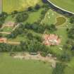 Oblique aerial view centred on the house, taken from the NW.