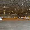 Interior.  Bellman type aircraft hangar showing metal roof trusses.