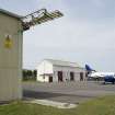 View.  Bellman type aircraft hangar withTriple Turret Trainer, type A in back ground. .  Detail of door gantry from SW.