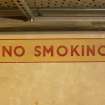 Interior. Basement, corridor, detail of WW II 'No smoking' sign