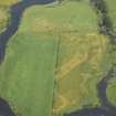 Oblique aerial view centred on the cropmarks of the settlement, taken from the SW.