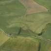 Oblique aerial view centred on the parchmarks of the enclosure, taken from the ENE.