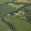 Oblique aerial view centred on the country house, castle, stables, lodge and walled garden, taken from the WSW.