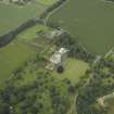 Oblique aerial view centred on the country house, castle, stables and lodge, taken from the S.