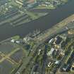 General oblique aerial view centred on the tall ship and wharf, taken from the NE.