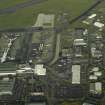 Oblique aerial view of the airport buildings, terminal and apron, taken from the SSE.