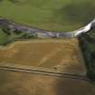 Oblique aerial view centred on the cropmarks of the fort and the possible causewayed enclosure, taken from the NE.