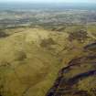 General oblique aerial view centred on the remains of the farmstead, rig, enclosure, sheephouse and sheepfolds with Edinburgh in the distance, taken from the S.