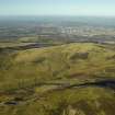 General oblique aerial view centred on the remains of the farmstead, rig, enclosure, sheephouse and sheepfolds with Edinburgh in the distance, taken from the ESE.