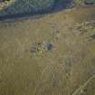 Oblique aerial view centred on the remains of the cairn and the sheepfold, taken from the E.