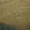 Oblique aerial view centred on the remains of the cairn and the sheepfold, taken from the WSW.