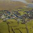 Oblique aerial view centred on the village, county building, court house, town hall and church, taken from the W.