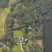 Oblique aerial view centred on the remains of the castle and crannog with the cottage and offices adjacent, taken from the NNE.
