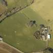 Oblique aerial view centred on the remains of the standing stones with the farmstead and cottage adjacent, taken from the SSE.