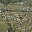 Oblique aerial view of the housing estate with the school adjacent, taken from the SE.