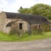 Curved roof building to SE of site, view from SW