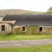 Curved roof building to SE of site, view from S