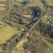 Oblique aerial view centred on the railway viaduct and the remains of the rig, mine and bing, taken from the W.