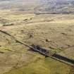 Oblique aerial view centred on the remains of the coal mines, bell pits and dismantled railway, taken from the NW.