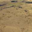 Oblique aerial view centred on the remains of the coal mines and bell pits, taken from the SE.