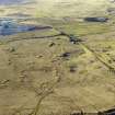 Oblique aerial view centred on the remains of the coal mines, bell pits and dismantled railway, taken from the ESE.