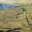 Oblique aerial view centred on the remains of the coal mines, bell pits and dismantled railway, taken from the E.