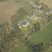 Oblique aerial view centred on the country house, garden and stables, taken from the S.