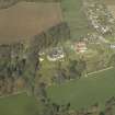 Oblique aerial view centred on the country house, garden and stables, taken from the SE.