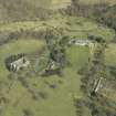 General oblique aerial view centred on the country house, stables, glasshouse and walled garden, taken from the SW.