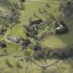 General oblique aerial view centred on the country house, stables, glasshouse and walled garden, taken from the NE.