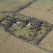 Oblique aerial view centred on the country house, walled garden, gate-lodges and cottage, taken from the E.