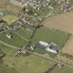 Oblique aerial view centred on the school with the church, burial ground and dovecot adjacent, taken from the SE.