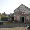 View of main gates to site and former retort house (latterly the coal store) which is now used as an exhibition space