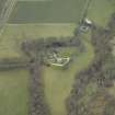 Oblique aerial view centred on the country house with stables, gate-lodge, gate piers and gates adjacent, taken from the NE.