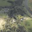 General oblique aerial view centred on the country house, stables and gardens with the house adjacent, taken from the W.