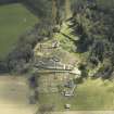 Oblique aerial view centred on the house, taken from the NW.