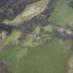 Oblique aerial view centred on the country house, walled garden, farmsteading, stables and dovecot, taken from the E.