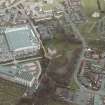 Oblique aerial view centred on the tower-house, stables and mills, taken from the W.