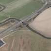 Oblique aerial view centred on the road bridges, taken from the SW.