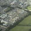 Oblique aerial view centred on the redevelopment of the hospital for housing with the school adjacent, taken from the SW.