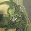 Oblique aerial view centred on the country house, cottage and church, taken from the W.