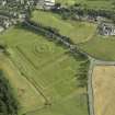 Oblique aerial view centred on the garden and earthwork, taken from the N.