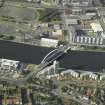 Oblique aerial view centred on the construction of the bridge, taken from the S.