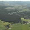 General oblique aerial view looking over Nethy Bridge towards the Grampian Highlands, taken from the NW.