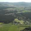 General oblique aerial view looking over Nethy Bridge towards the Grampian Highlands, taken from the NW.